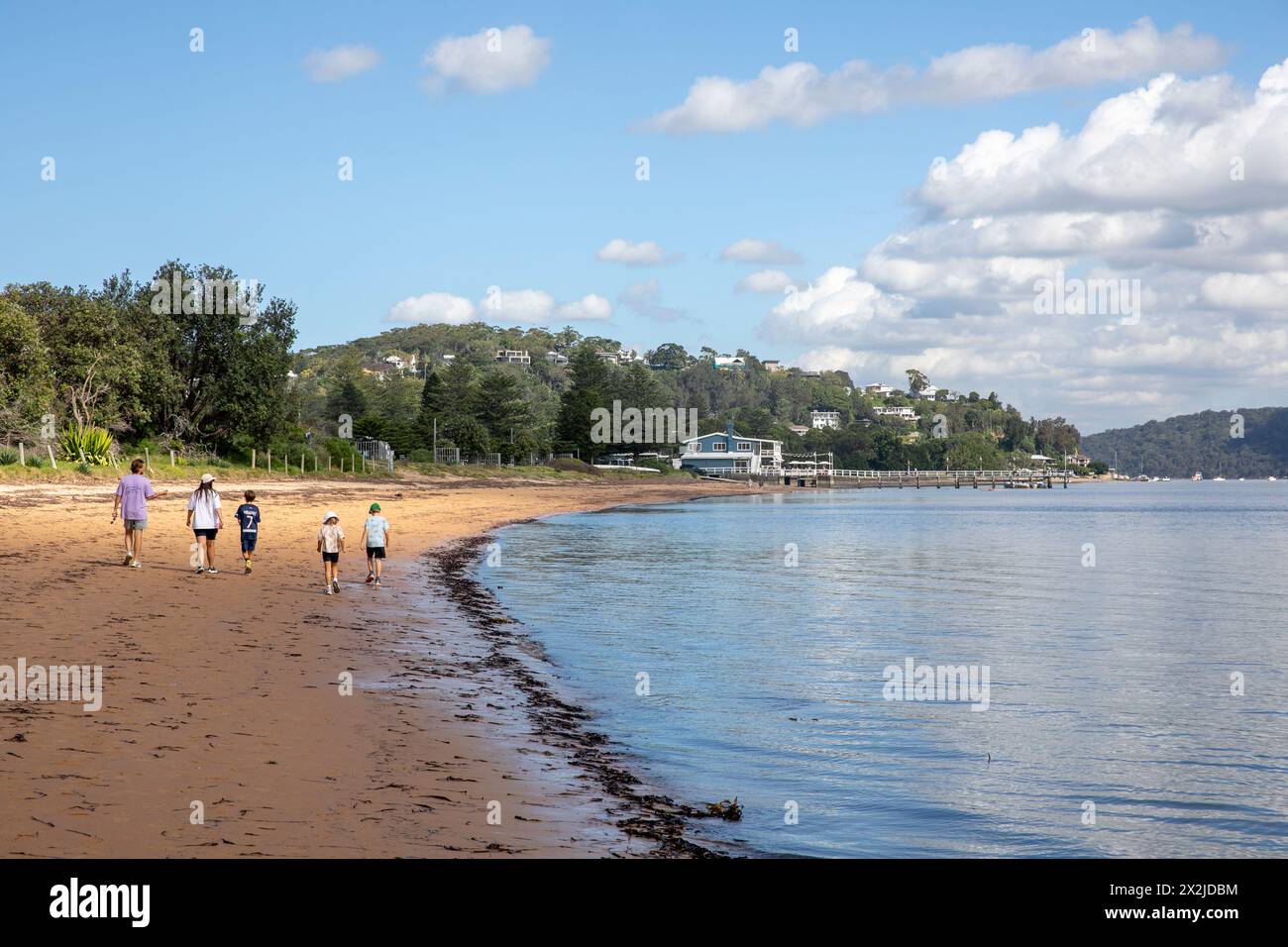 Young family with children enjoying walk along station beach in Palm Beach suburb of Sydney,NSW,Australia Stock Photo