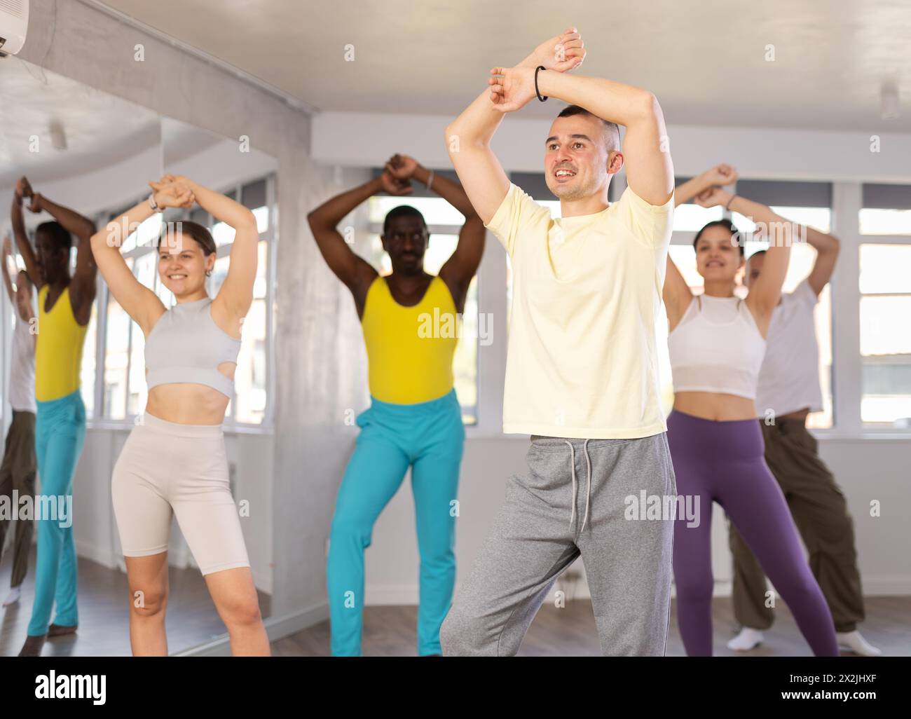 Young man learning dynamic dances at group choreography class Stock Photo