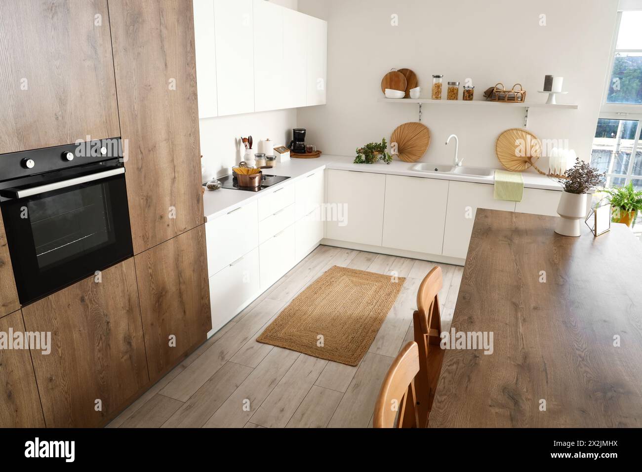 Interior of modern kitchen with white furniture and island table Stock ...