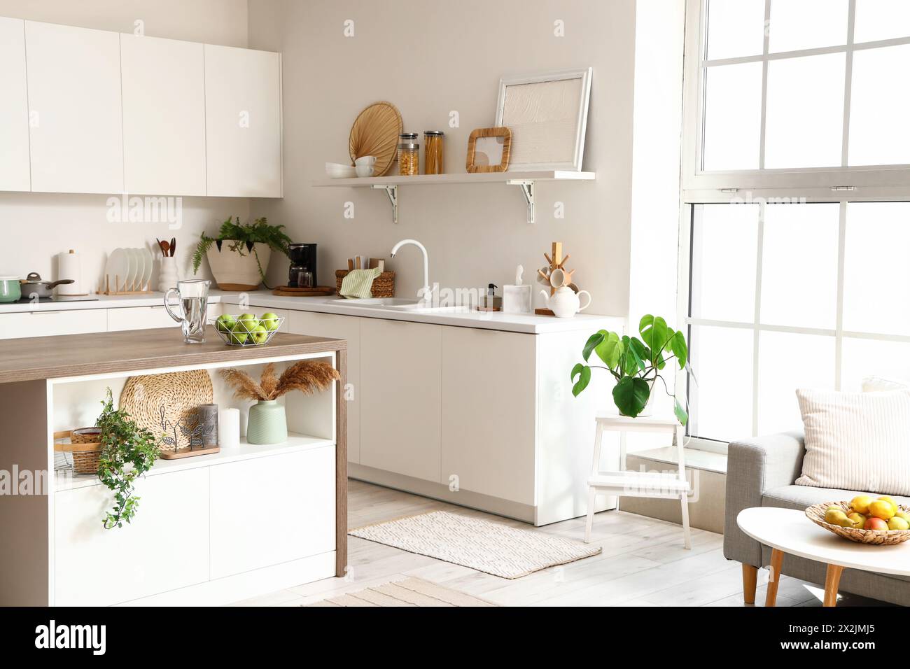 Interior of modern kitchen with white furniture and island table Stock ...