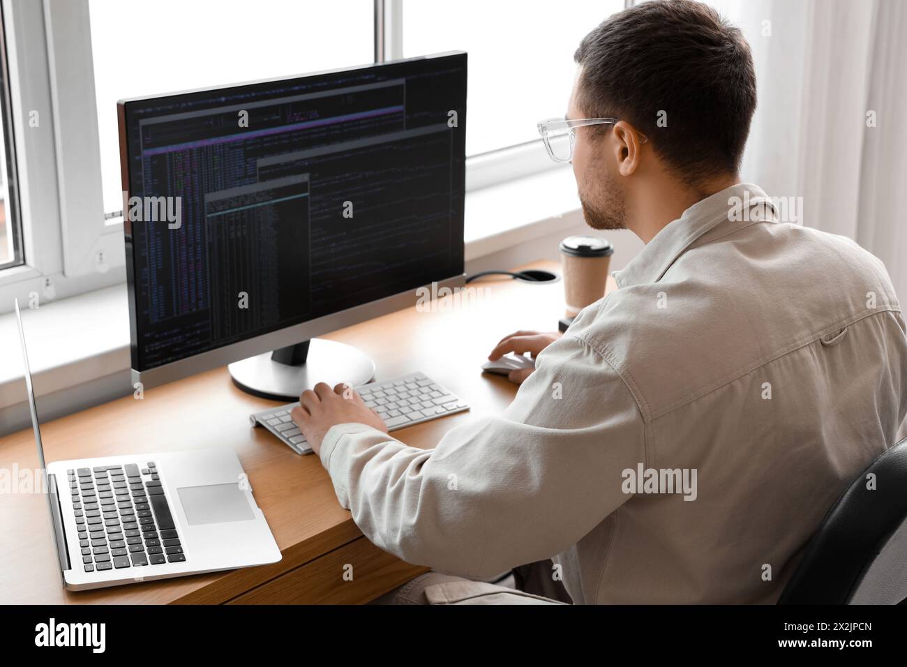 Focused male programmer working in office Stock Photo