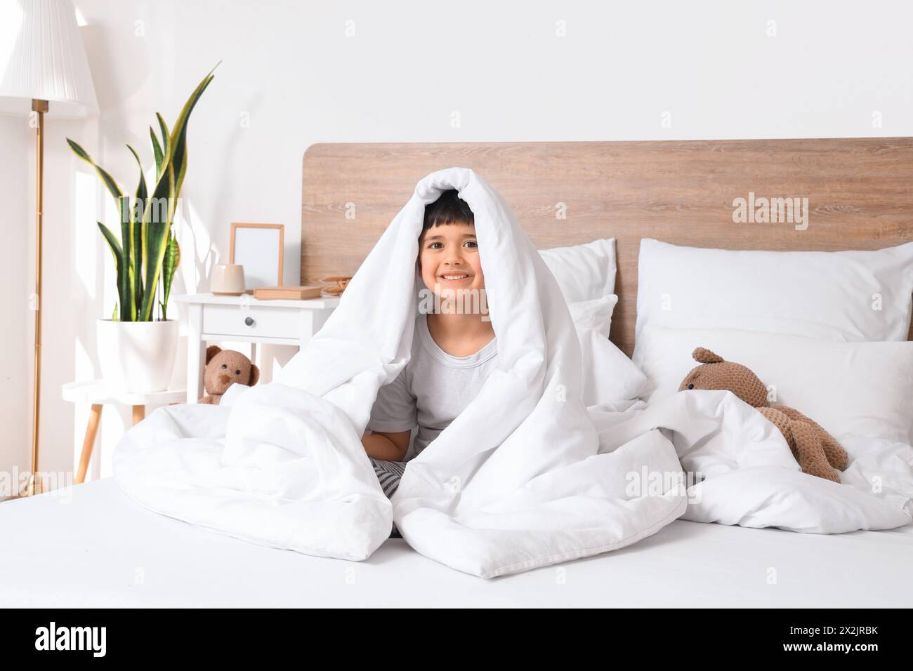 Cute happy little boy with teddy bear in bedroom Stock Photo - Alamy
