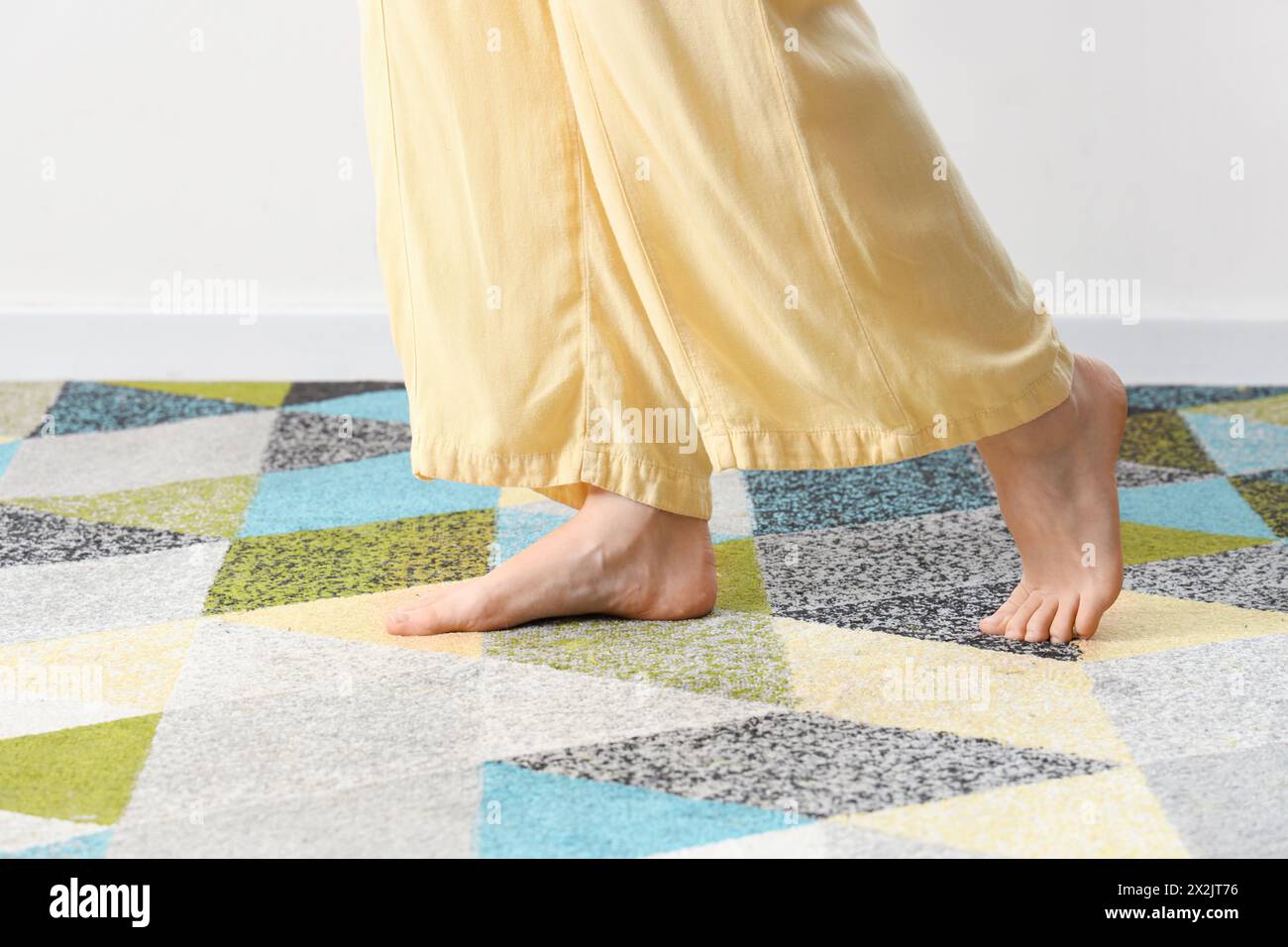 Walk On Rug Barefoot woman walking on colorful carpet at home, closeup Stock Photo ...