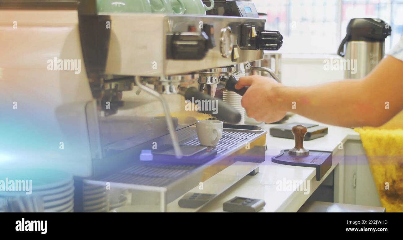 Image of glowing blue light over caucasian male barista making coffee Stock Photo