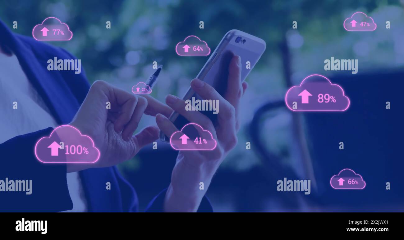 Image of pink cloud symbols uploading data over caucasian businesswoman using smartphone Stock Photo