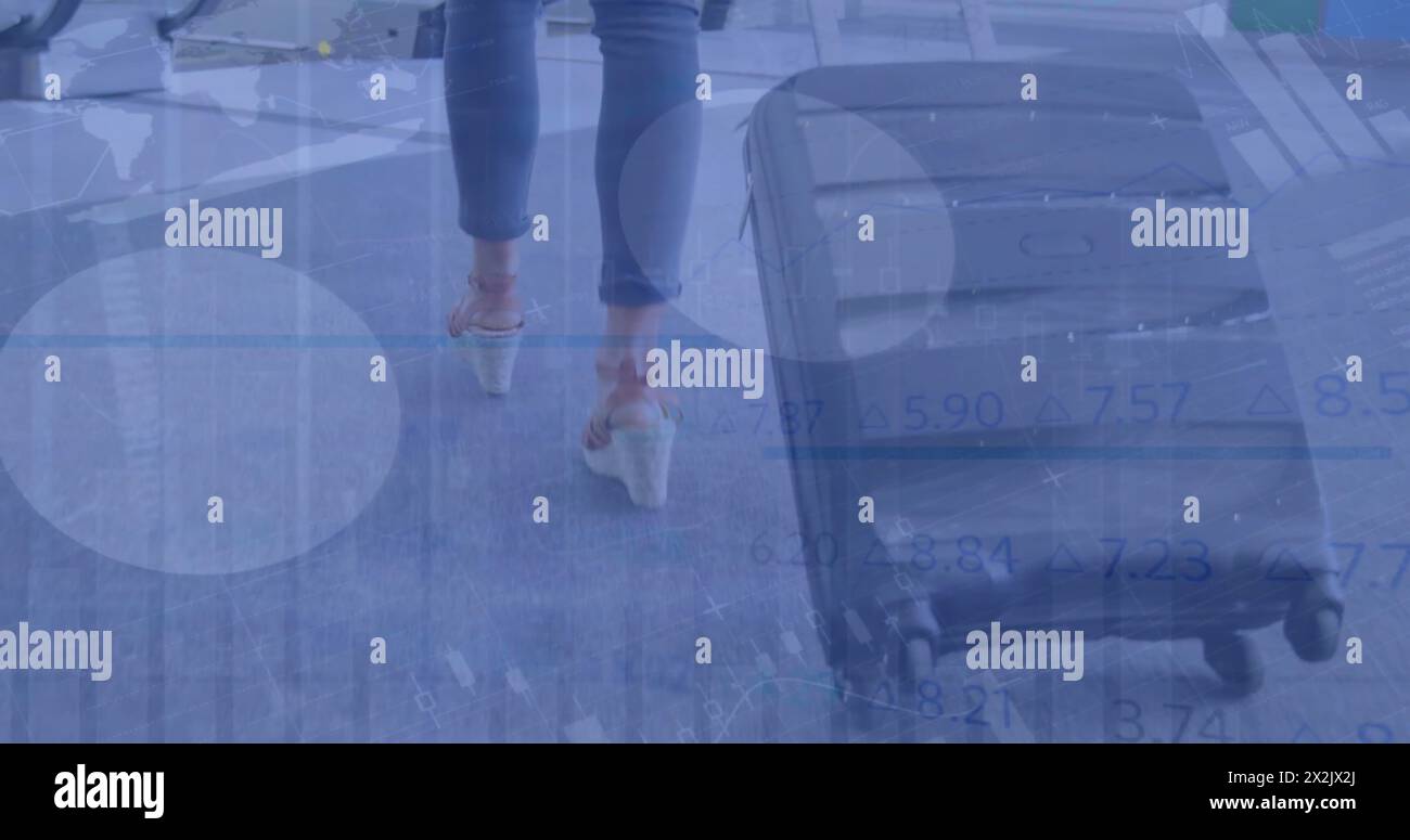 Image of financial data processing over caucasian woman walking with suitcase on street Stock Photo