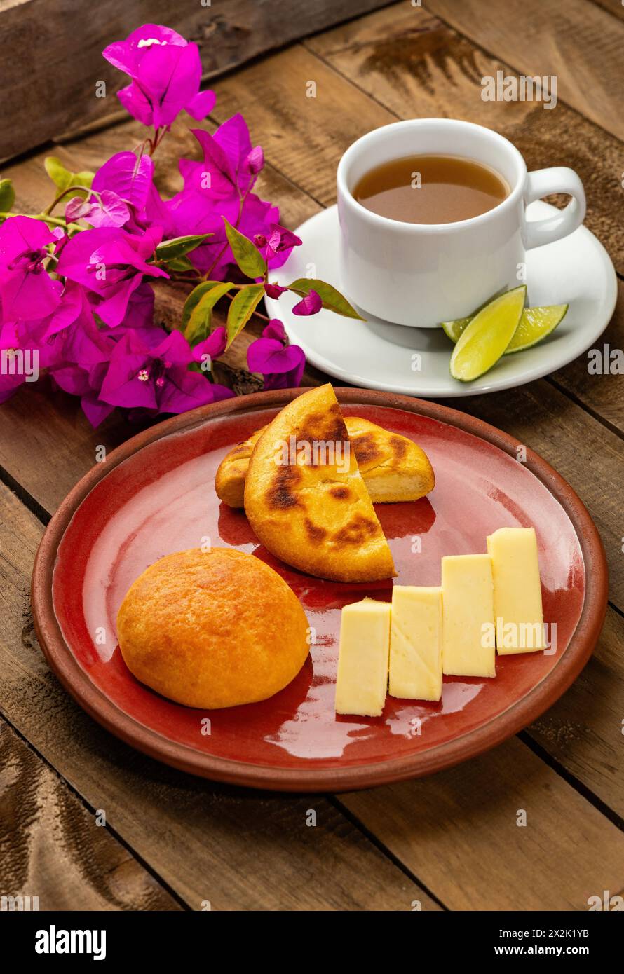 Arepa, almojabana, cheese and hot aguapanela - Typical Colombian breakfast Stock Photo