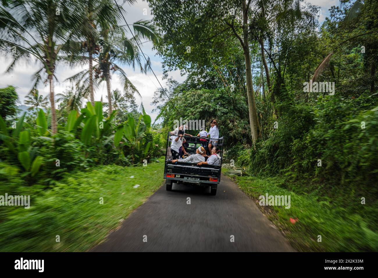 A group of friends experience joy while riding in the back of a pickup