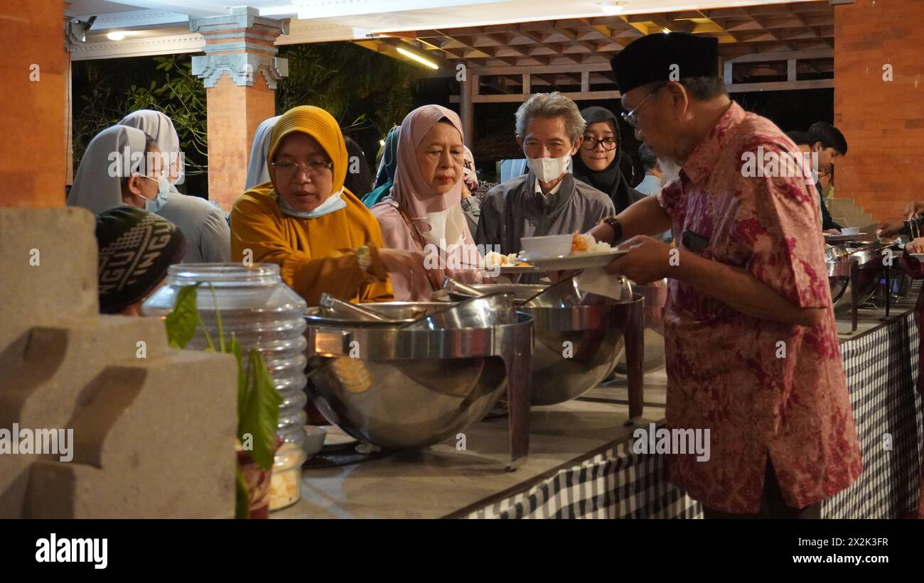 People take food in hotel buffet on the night of Halal Bihalal event Stock Photo