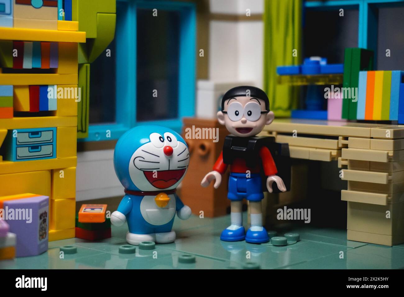 Doraemon and Nobita figures are standing in Nobita's room while using a ...