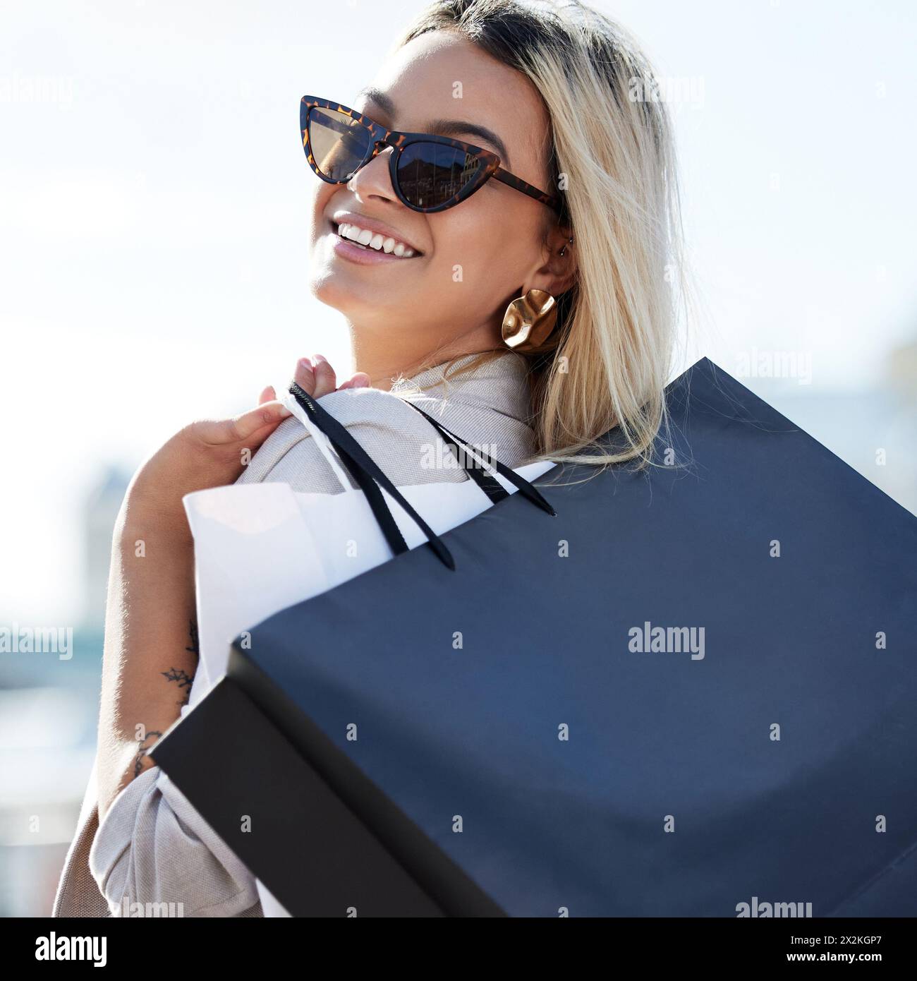 Woman, shopping bags and smile with sunglasses in portrait with retail therapy for purchase with buying. Consumerism, confidence and happiness with Stock Photo