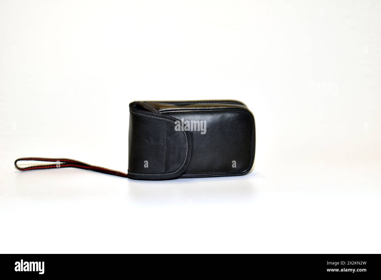 Leather case for storing and transporting a digital camera. Stock Photo