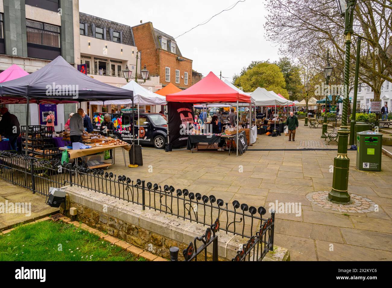 Market stalls and shoppers at the Saturday open air market at Carfax in Horsham, West Sussex, England. Stock Photo