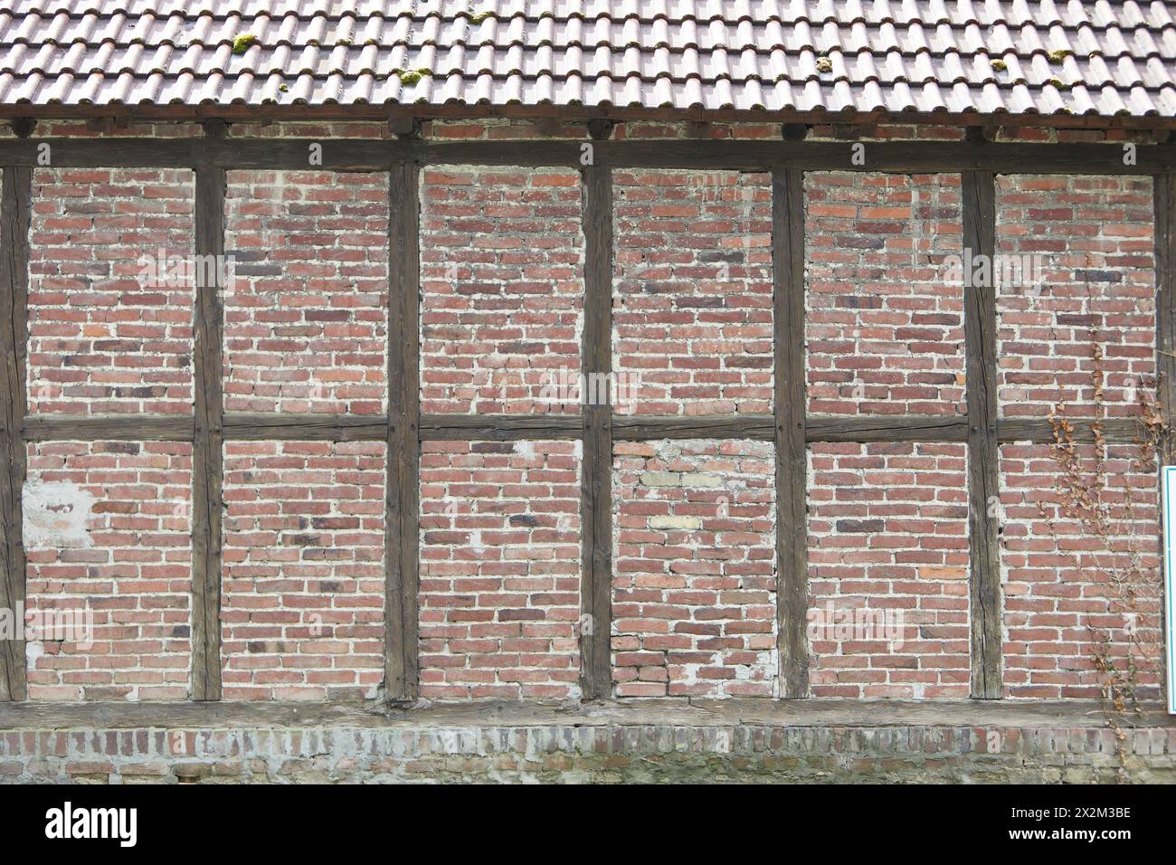red and brown half-timbered wall with bricks Stock Photo
