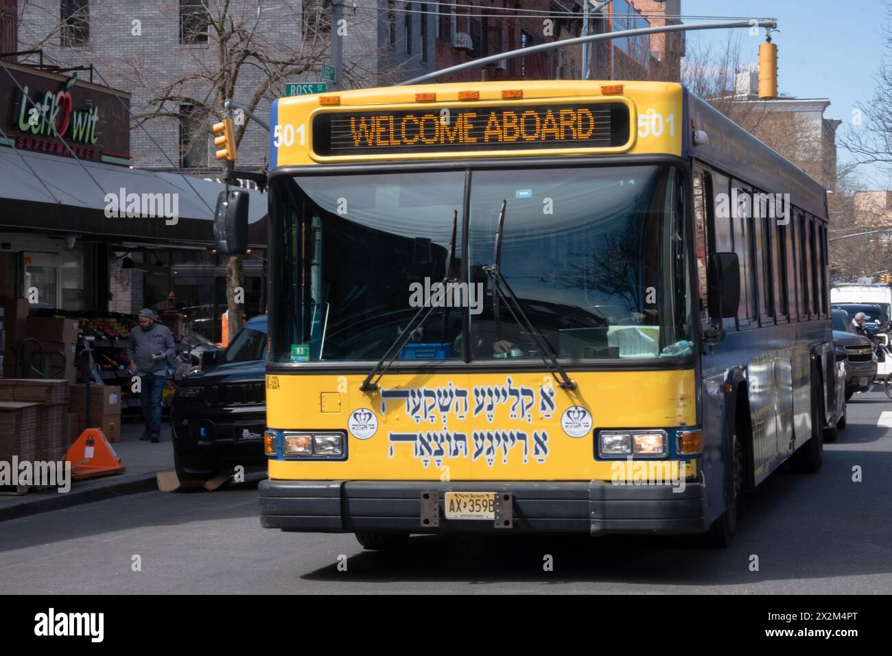 A private bus that runs between the orthodox Jewish neighborhoods of Williamsburg & Boro Park. On Lee Avenue & with Yiddish writing on the front. Stock Photo