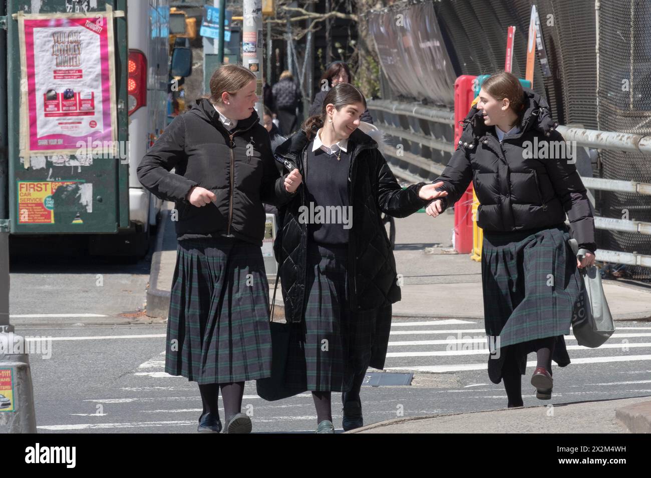 Classmates at a parochial school for religious Jewish girls head home while having an animated conversation. On Bedford Avenue in Williamsburg, NYC. Stock Photo