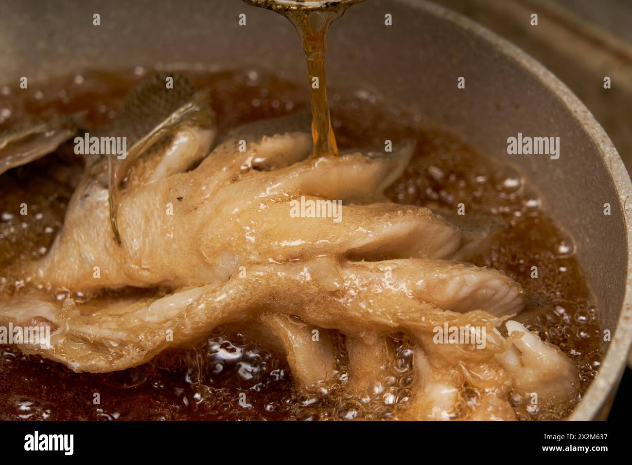 Cheff Fish A chef in the kitchen is making fried fish, frying a whole fish Stock ...
