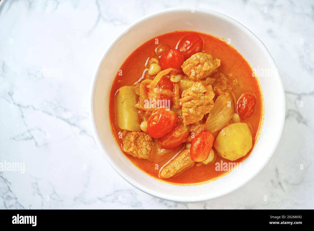 Pork Massaman curry, Thai curry with the taste of sweet and a little spicy taste. Tip view image of Massaman curry on a white marble table with natura Stock Photo