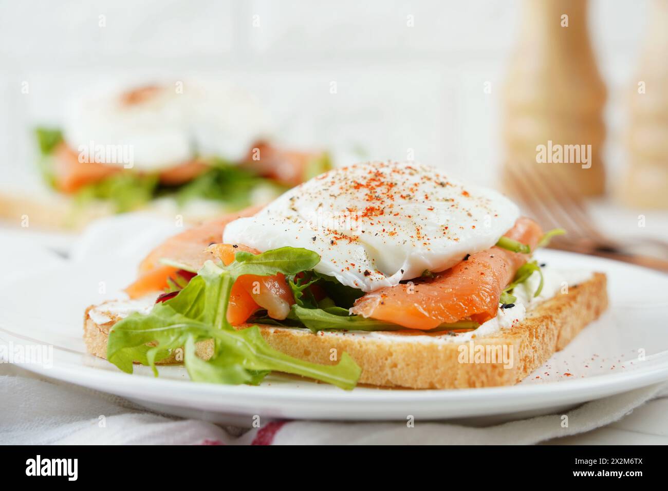 Eggs Benedict with smoked salmon, herbs, and hollandaise sauce Stock Photo
