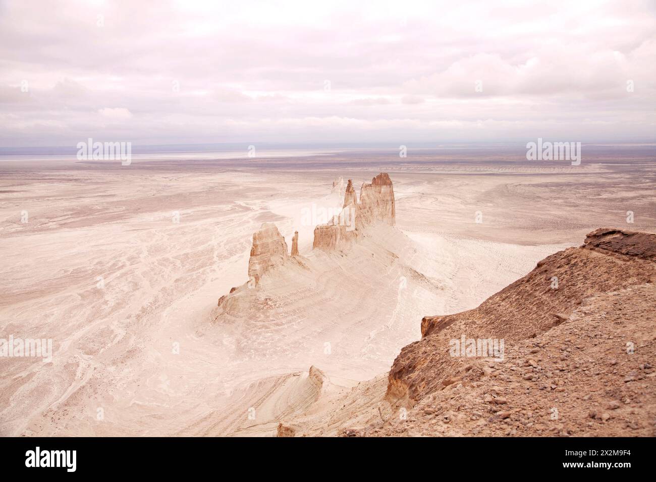 Bozzhyra tract in Kazakhstan, a scenic and arid desert landscape featuring dramatic rock formations and sediment layers. Stock Photo