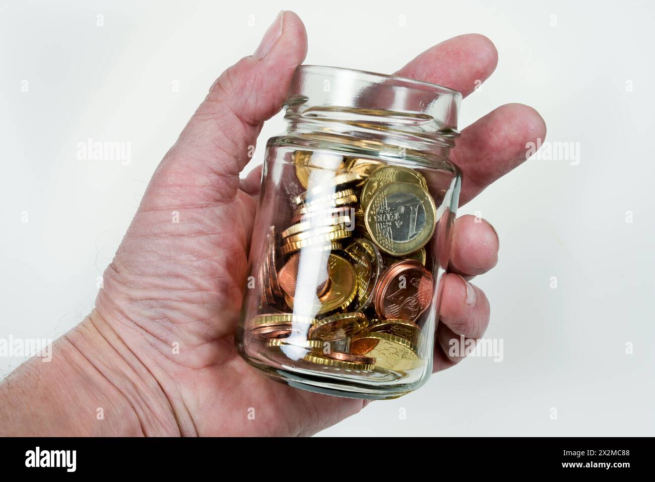 Euros und Centmünze im Glas, Symbolfoto Sparen, Sparsamkeit *** Euros and cent coin in a jar, symbolic photo Saving, thriftiness Stock Photo