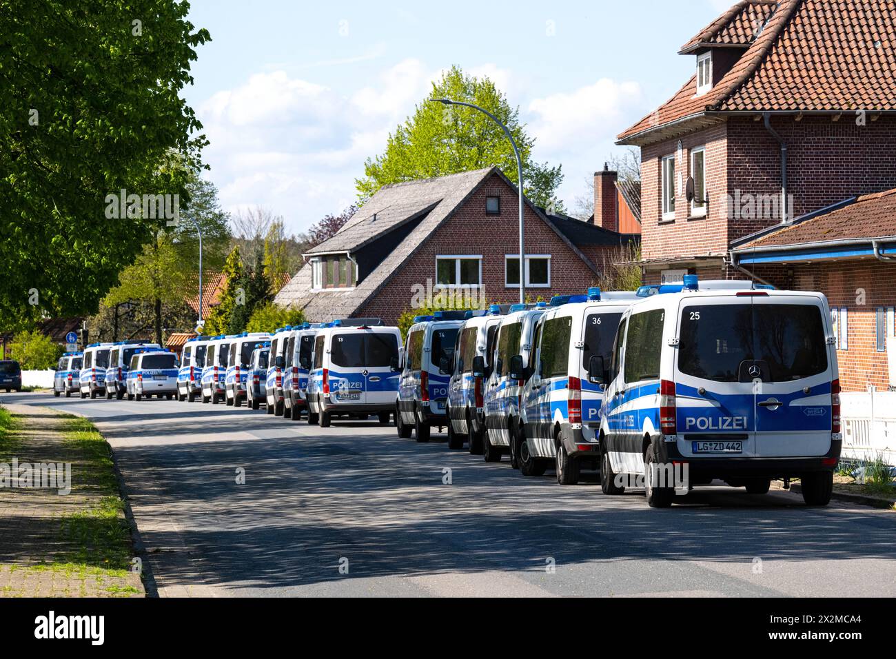 Lower Saxony, Germany. 23 April 2024, Lower Saxony, Bremervörde: Numerous emergency vehicles are parked along a road. More than three hundred emergency services have been searching for a missing six-year-old child in Bremervörde, Lower Saxony, since Monday evening. As the police announced on Tuesday, the boy is autistic and does not respond to being spoken to. Credit: dpa picture alliance/Alamy Live News Stock Photo