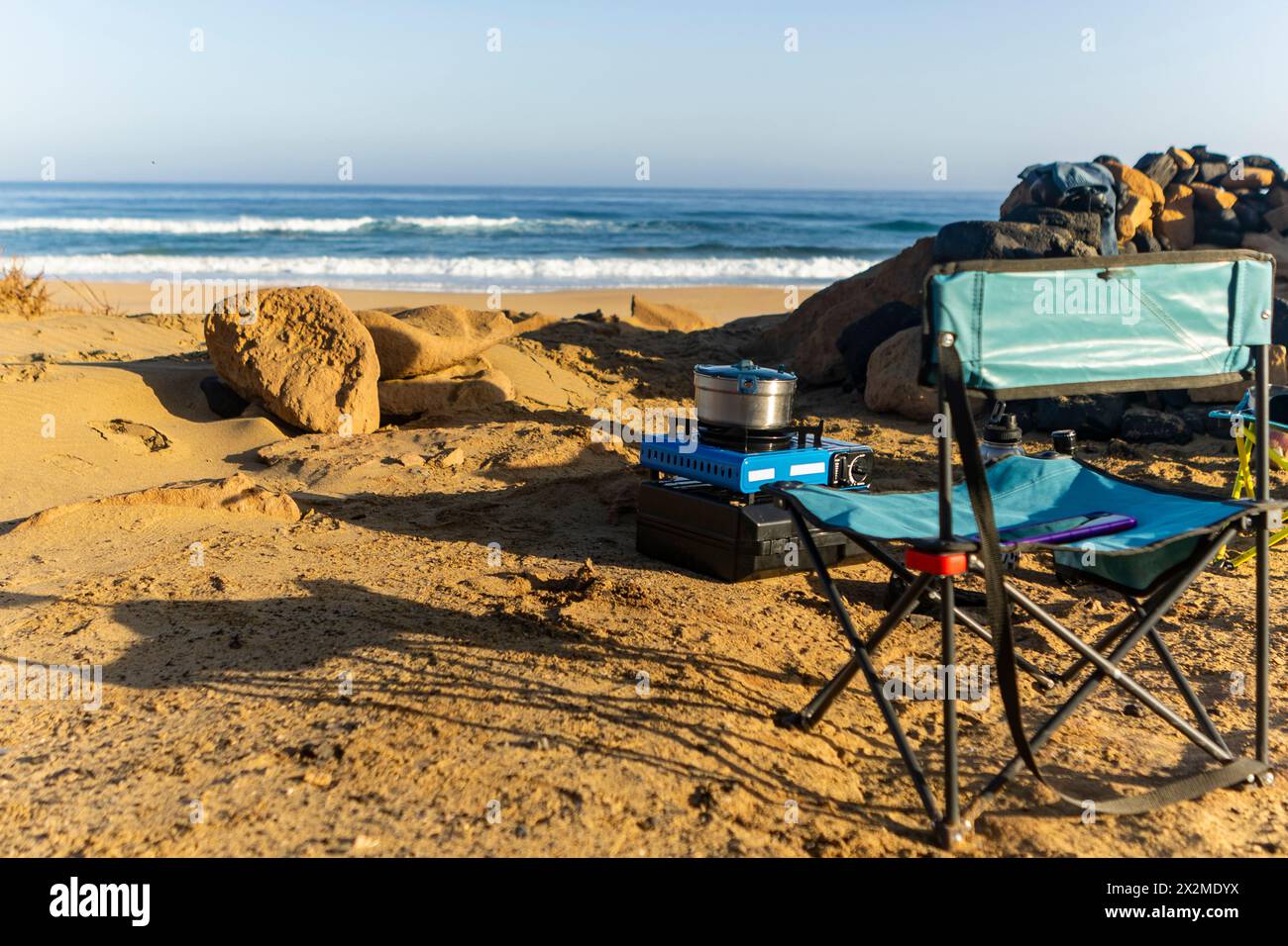 A serene beach camping scene with a portable stove and chair set up on the  sandy shores of Fuerteventura in the Canary Islands, offering an idyllic ou  Stock Photo - Alamy