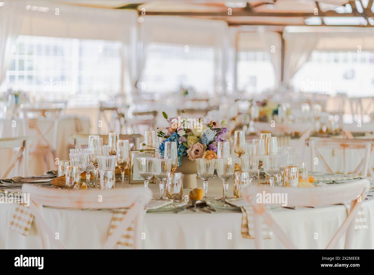 Elegant wedding reception table setup with floral centerpiece and fine china Stock Photo