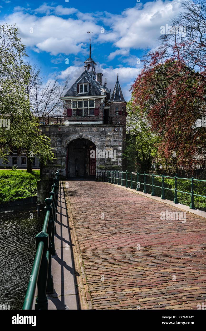 View of the renaissance architecture Oosterpoort city gate from the golden age and adjoining bridge in the Dutch city of Hoorn under a blue clouds sky Stock Photo
