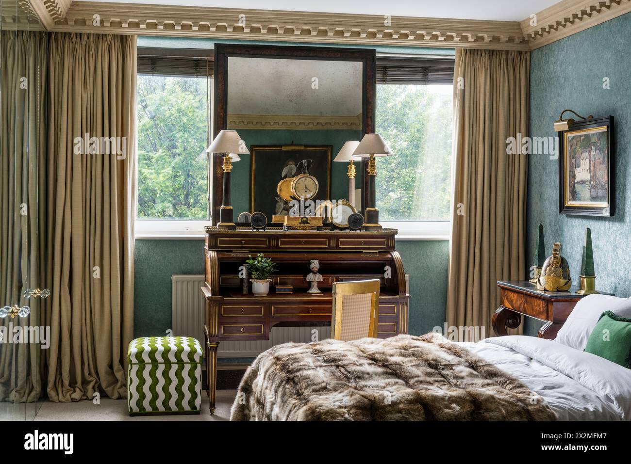 Pair of lamps on writing desk in window of Chelsea apartment, London UK Stock Photo