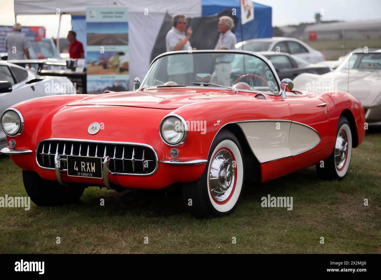 Three-quarters front view of a 1957, Red and White, Chevrolet  Corvette, on display at the 2023 British Motor Show Stock Photo