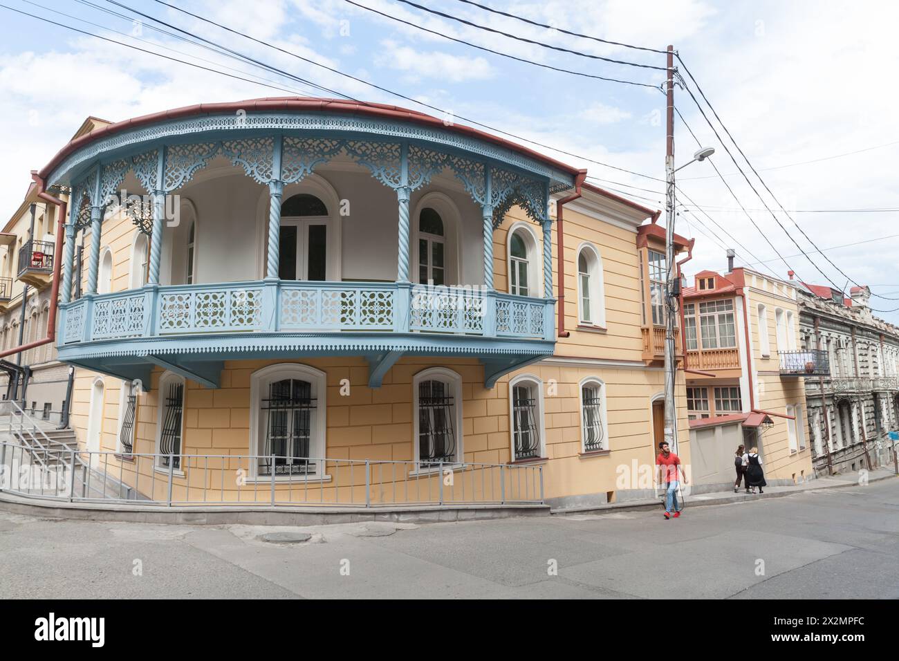 Tbilisi, Georgia - May 3, 2019: Tbilisi street view with people walking near old residential houses with balconies Stock Photo
