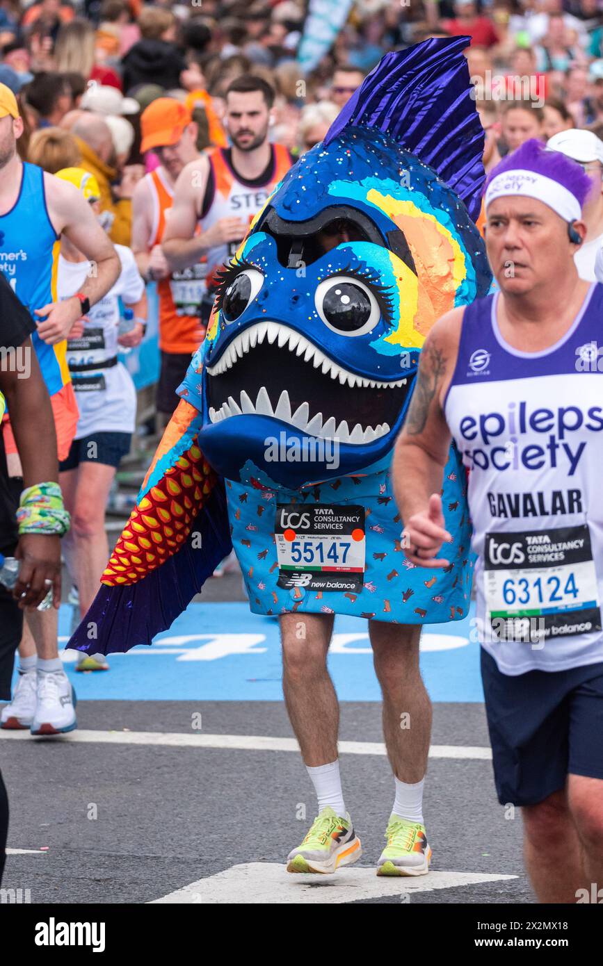 Joel Dommett participating in the TCS London Marathon 2024 passing through Tower Hill, London, UK. Running in a fish costume Stock Photo