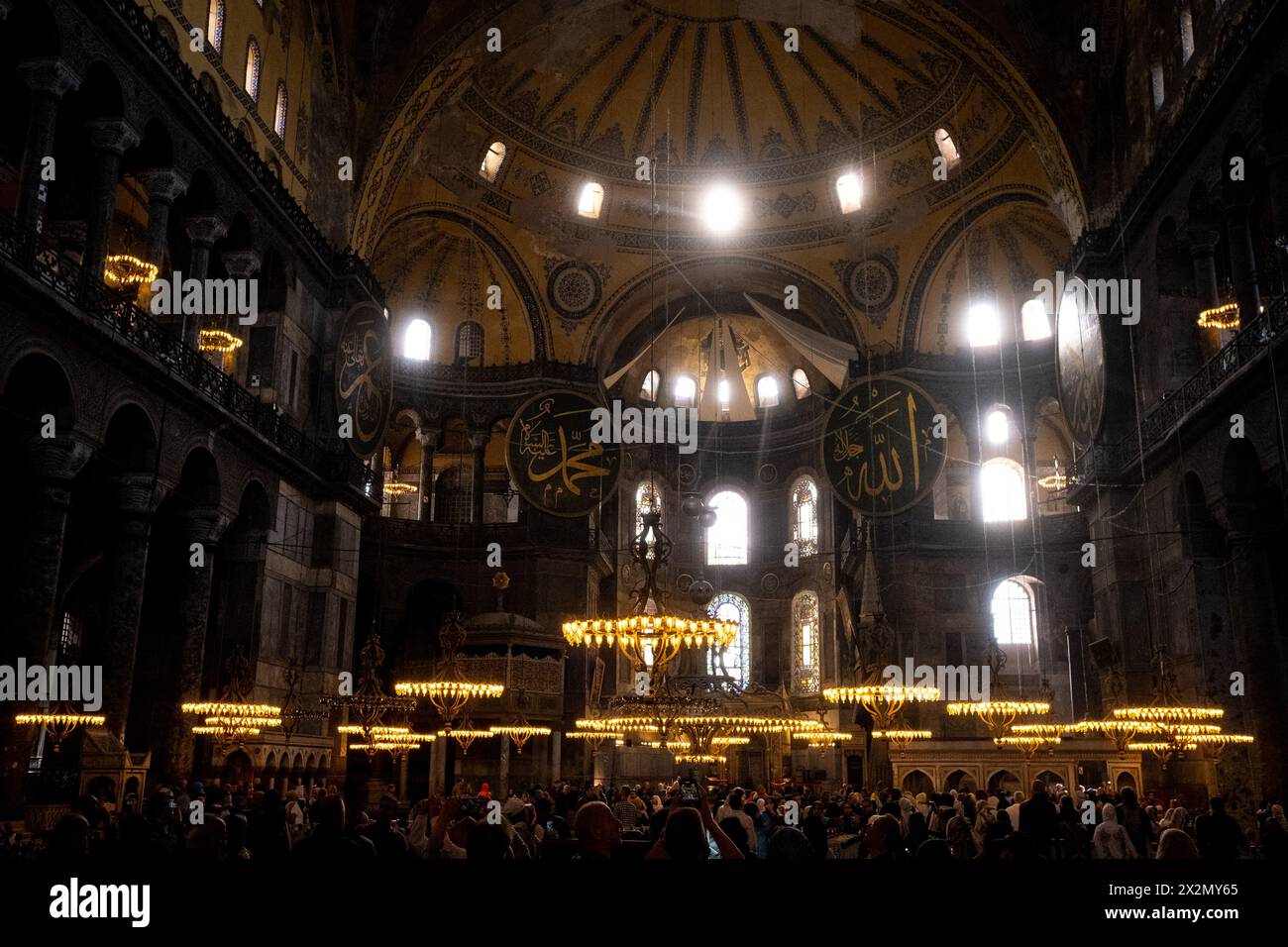 Visiting tourists inside the Great Mosque of Saint Sophia, originally a Christian basilica and the most important monument of Byzantine architecture, Stock Photo