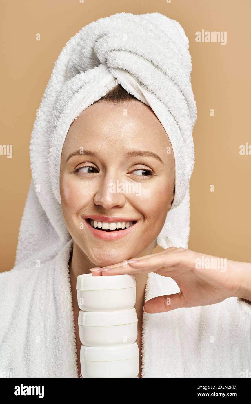 A beautiful woman with a towel wrapped around her head posing ...