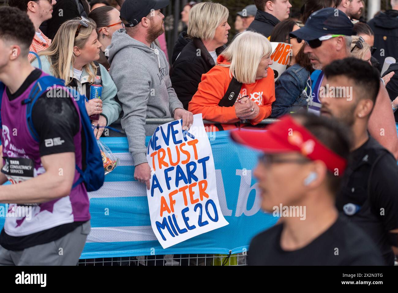 Humorous placard participating in the TCS London Marathon 2024 passing