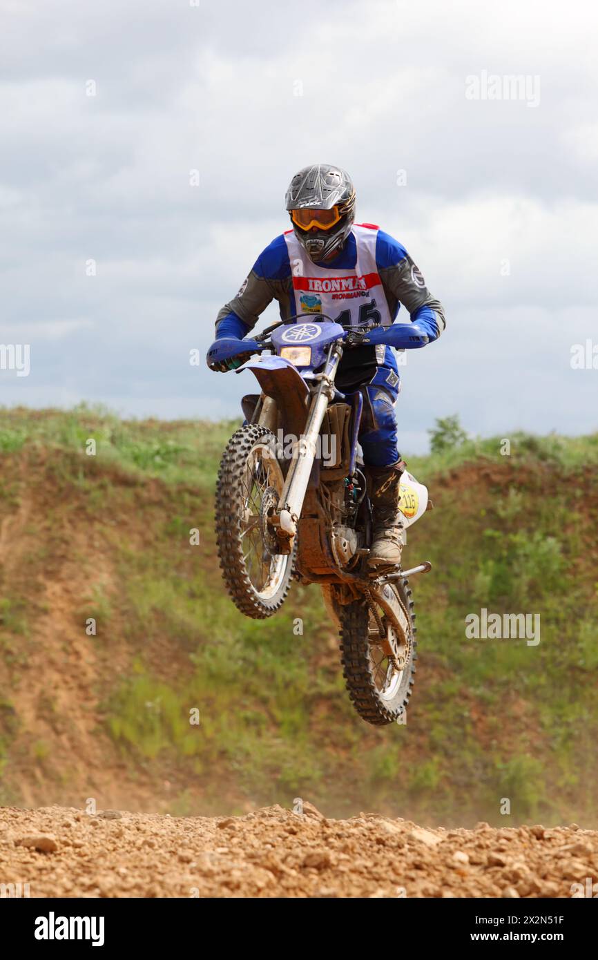 RAKOVO - JUNE 4: Motor-cyclist jumps at first stage of race in enduro-cross series IronManmotorcycling at X-ARENA on June 4, 2011 in Rakovo village ne Stock Photo
