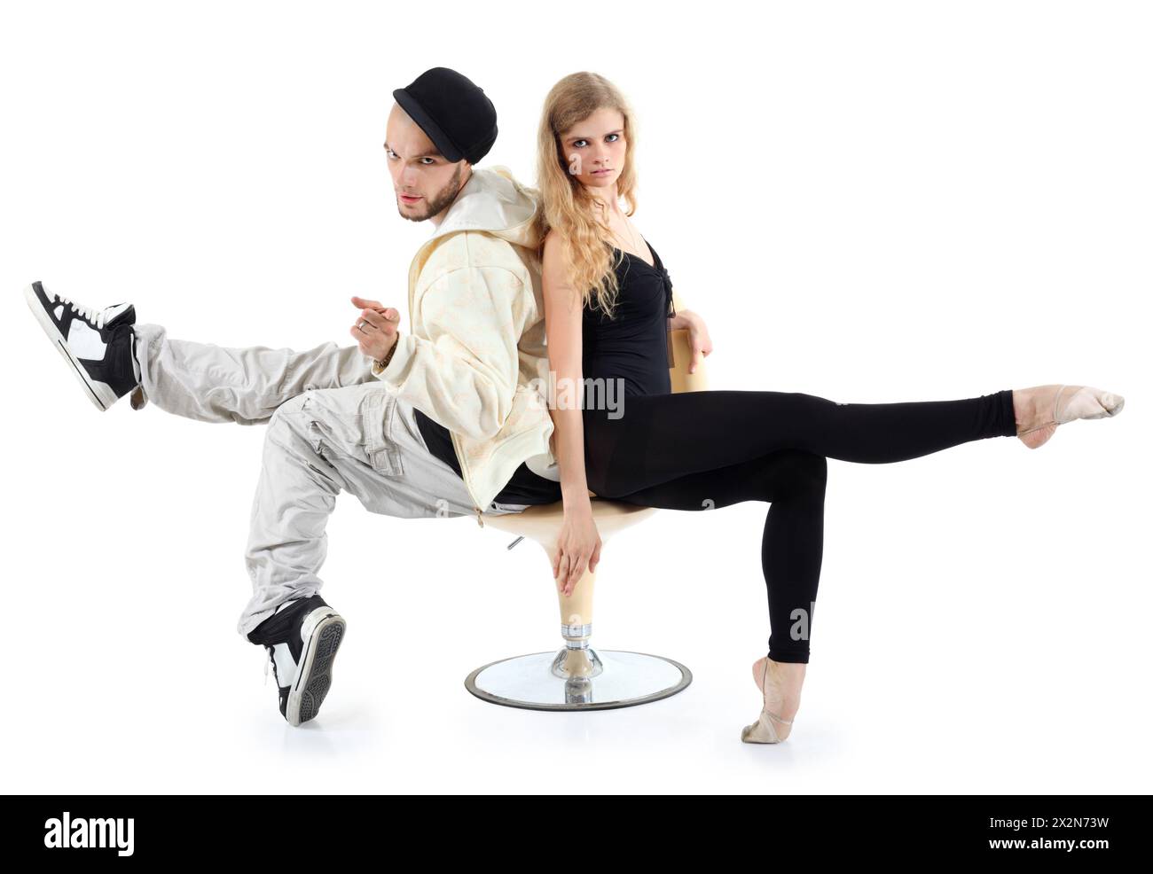 Rapper and ballerina sit on yellow chair and look at camera isolated on ...