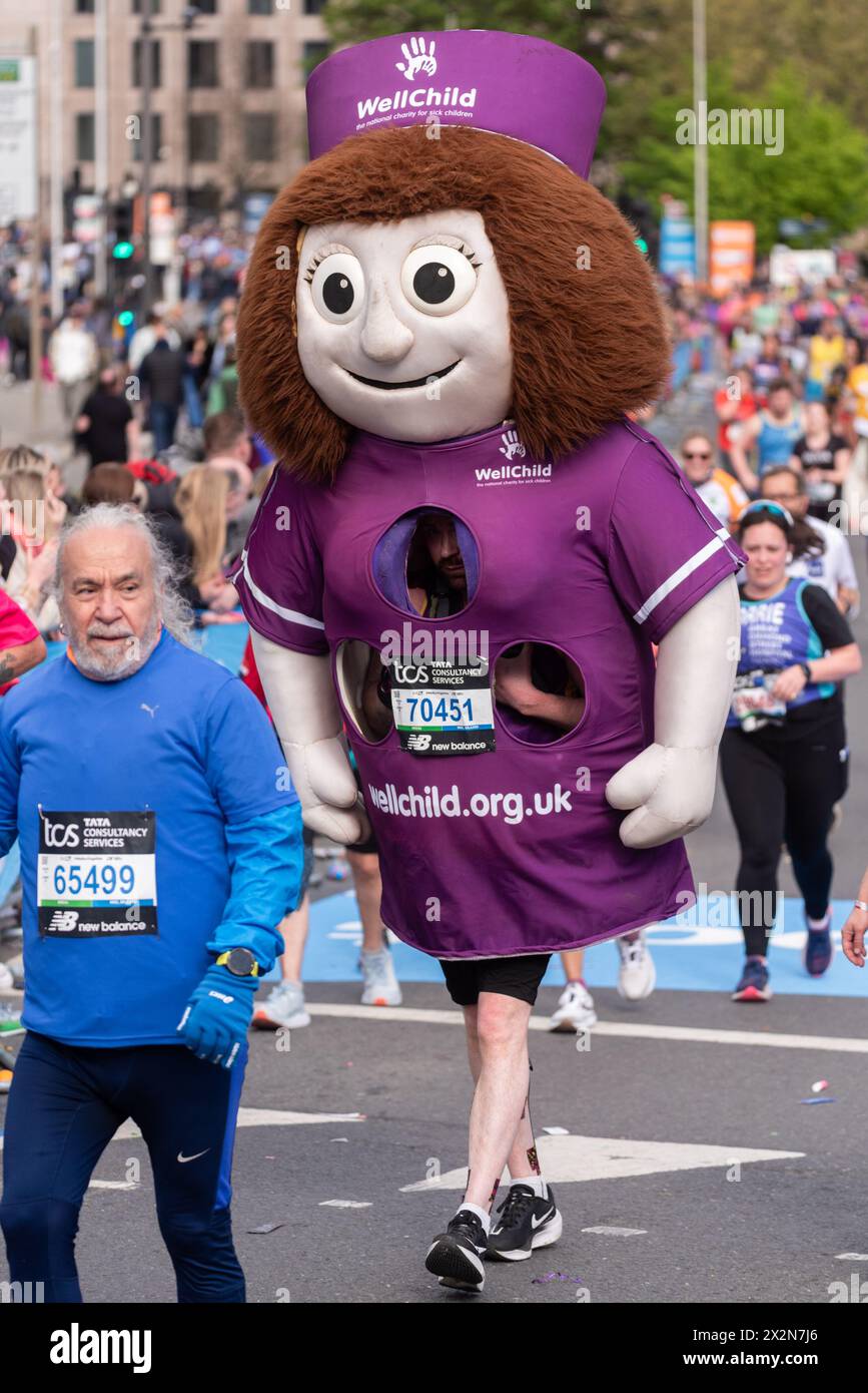 James Mccaffrey participating in the TCS London Marathon 2024 passing through Tower Hill, London, UK, wearing huge wellchild Nina the nurse costume Stock Photo