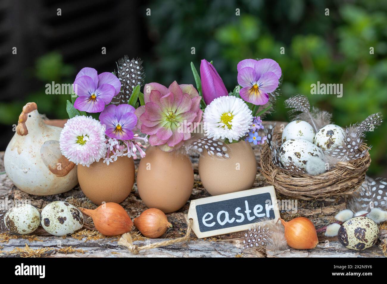 easter arrangement wirth eggs decorated with spring flowers Stock Photo