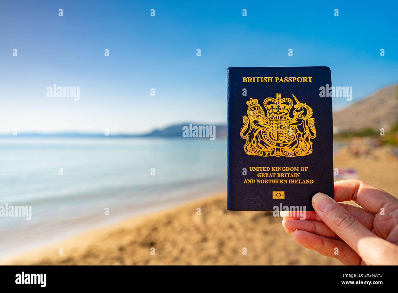 Hand holding new passport hi-res stock photography and images - Alamy