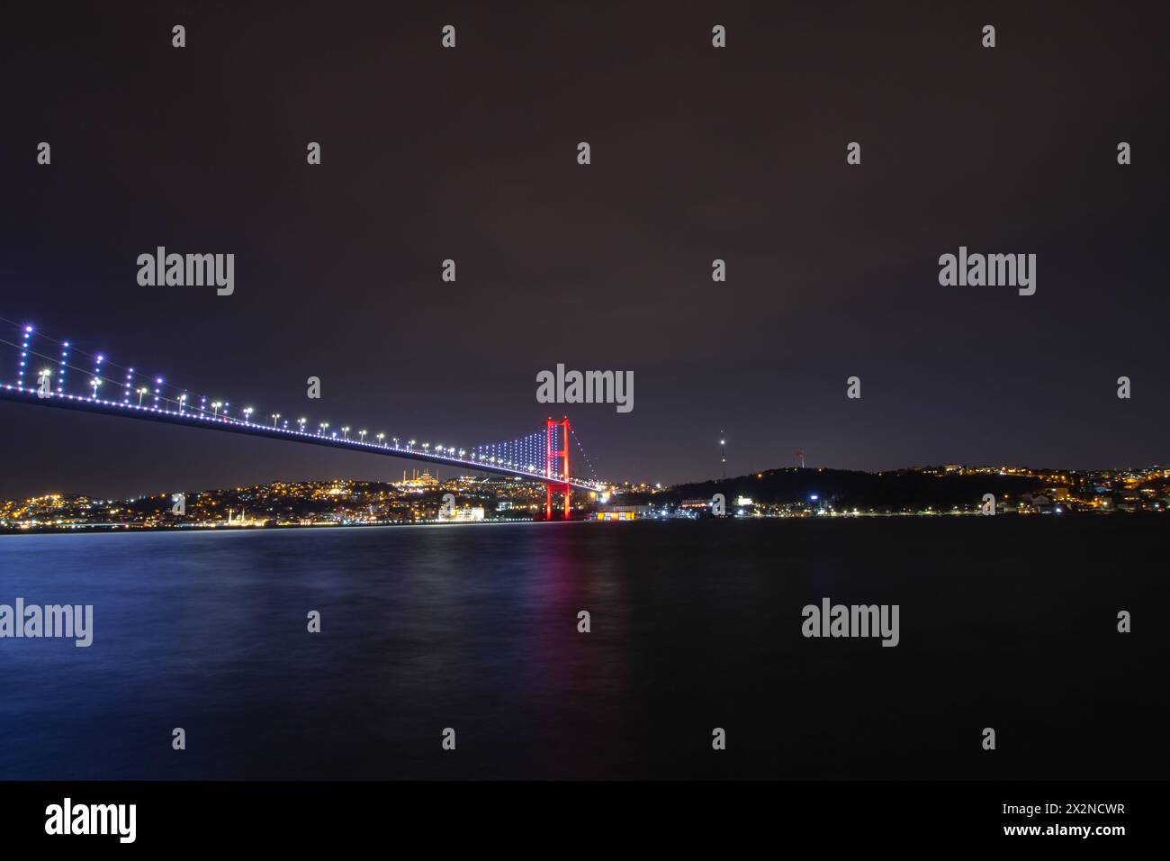 Bosphorus Bridge aka 15 temmuz sehitler koprusu and Anatolian side of Istanbul view at night. Stock Photo