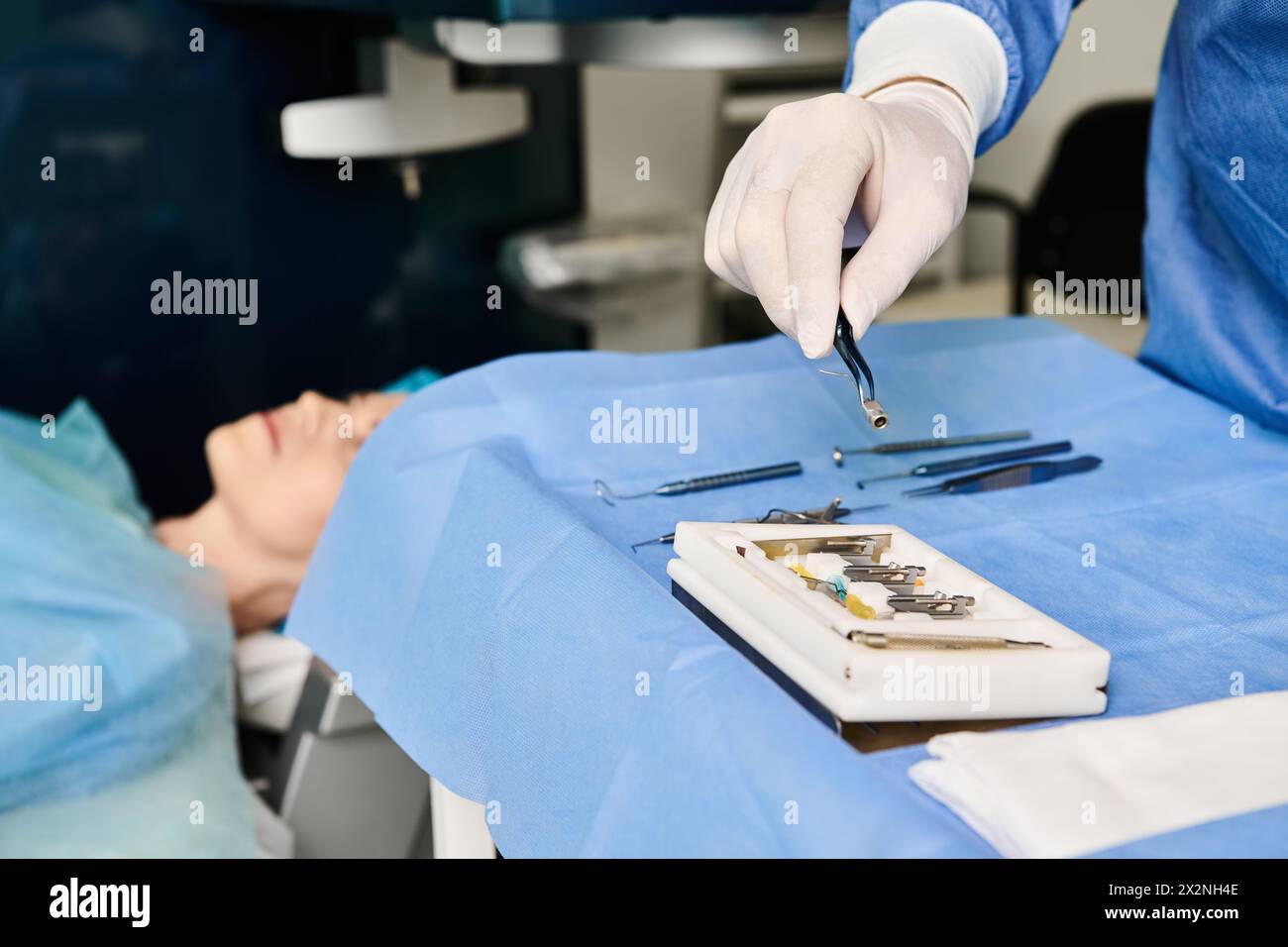 A person in a hospital bed receiving medical attention from healthcare professionals. Stock Photo
