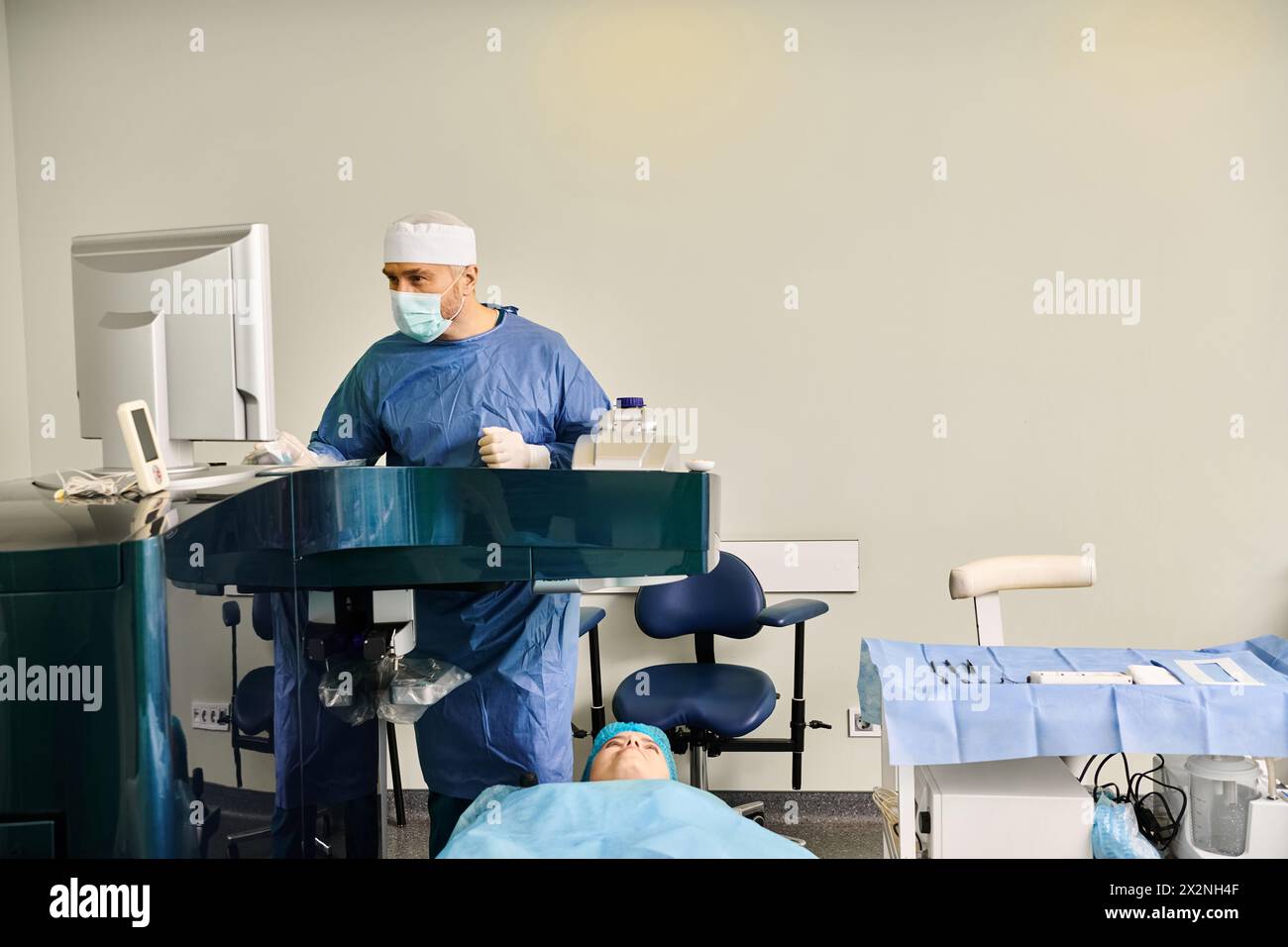 Surgeon in scrubs operating precision machine in medical setting. Stock Photo