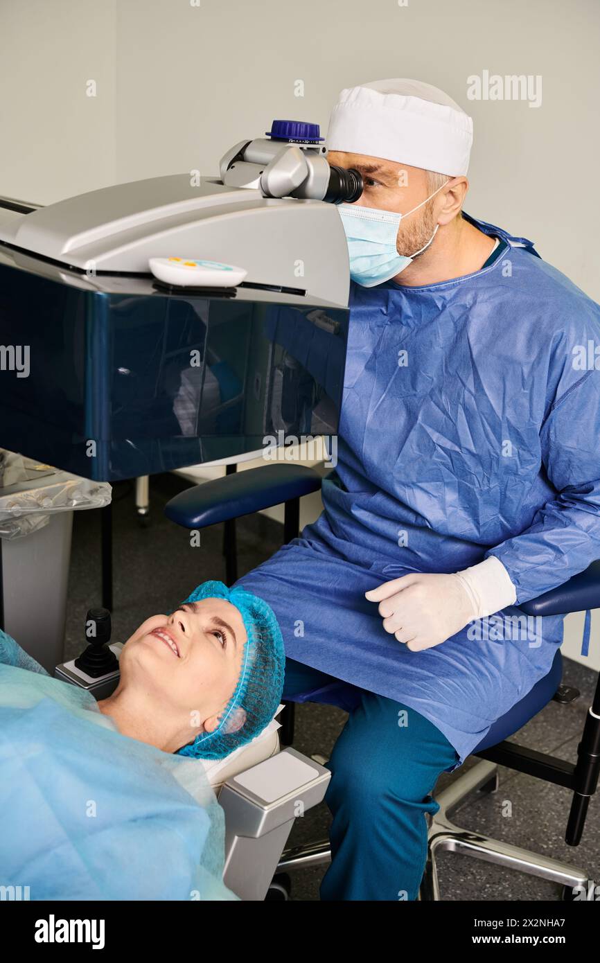 A doctor examines a man in a surgical gown. Stock Photo