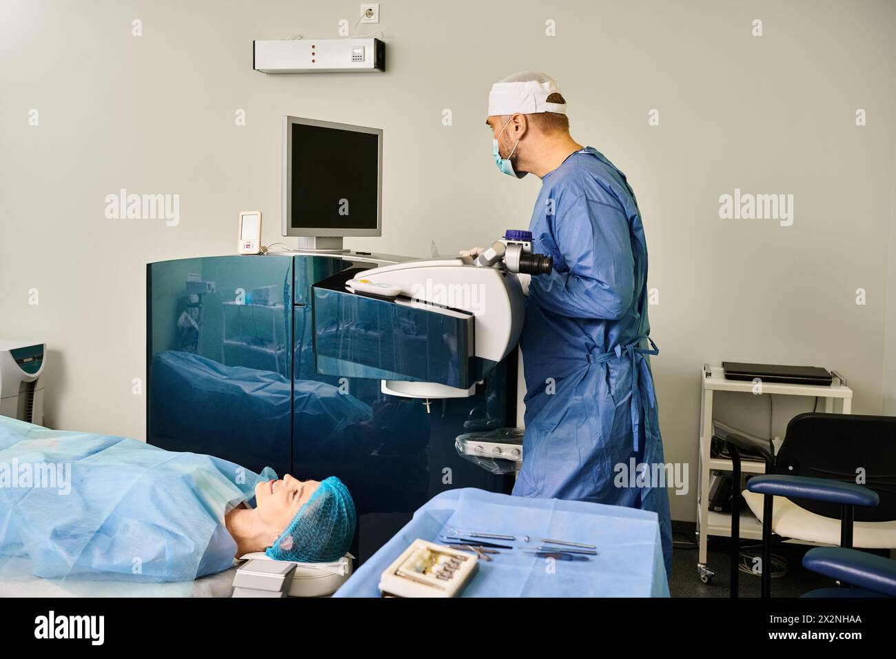 A person in a hospital bed connected to a monitor showing vital signs. Stock Photo