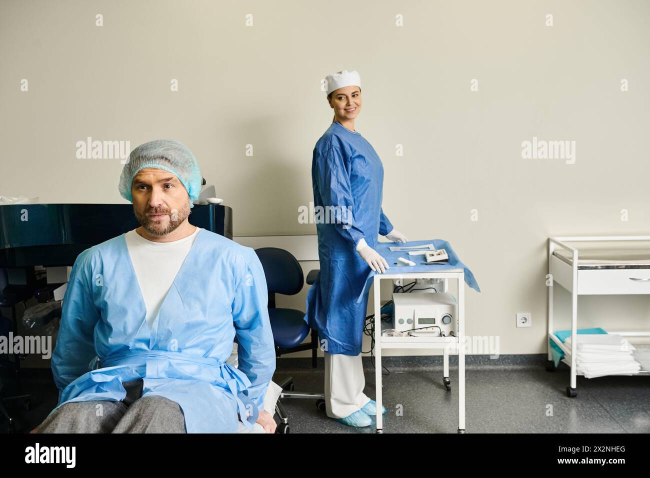 A man in a chair next to a woman in scrubs, discussing laser vision correction. Stock Photo
