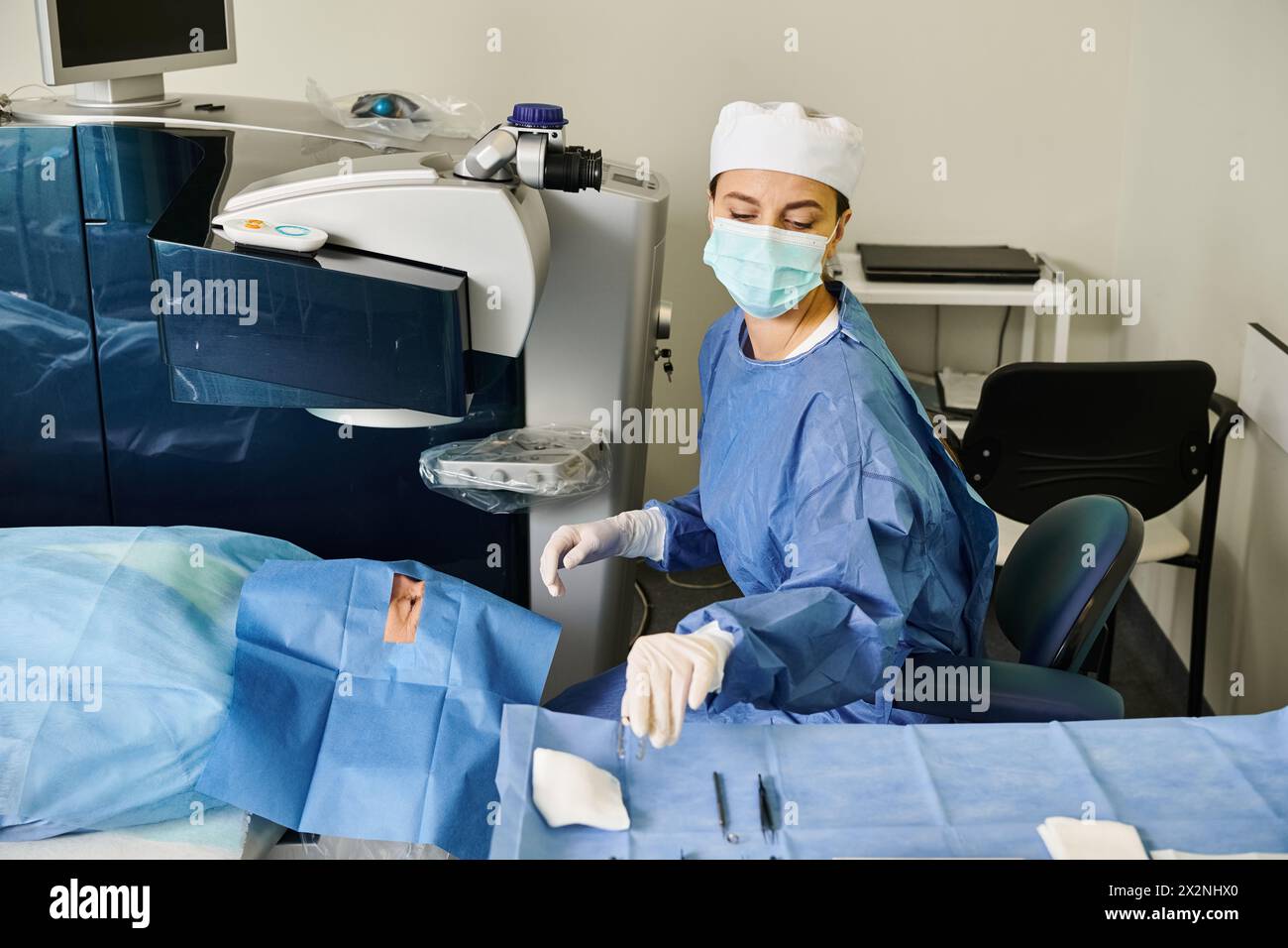 A woman wearing a surgical mask in a hospital room during a medical procedure. Stock Photo
