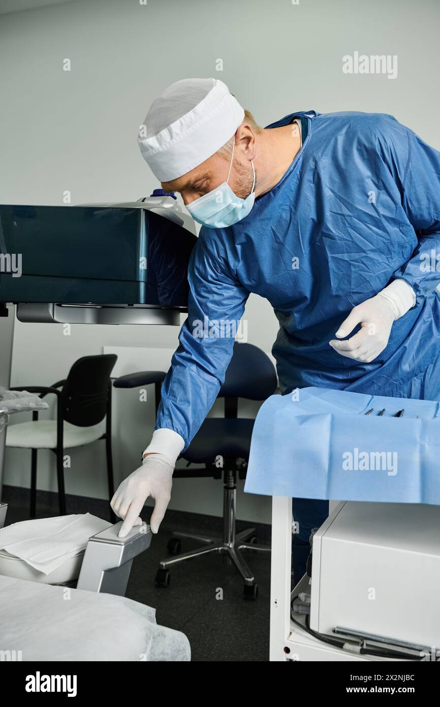 A man in a surgical gown and mask preparing tools. Stock Photo