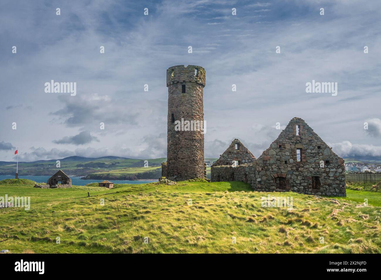 Scenic image in the grounds of the historic Peel Castle and Abbey on the west coast of the Isle of Man, seen here with the castle's defensive tower Stock Photo